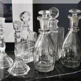 G01. Crystal decanters and glass candlesticks. 
